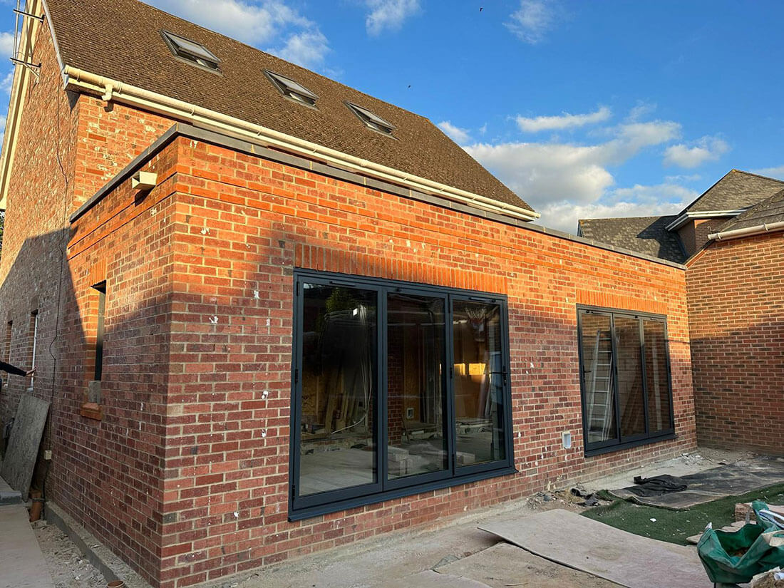 A completed brick extension with soldier courses over the openings and clean, even pointing across the whole elevation