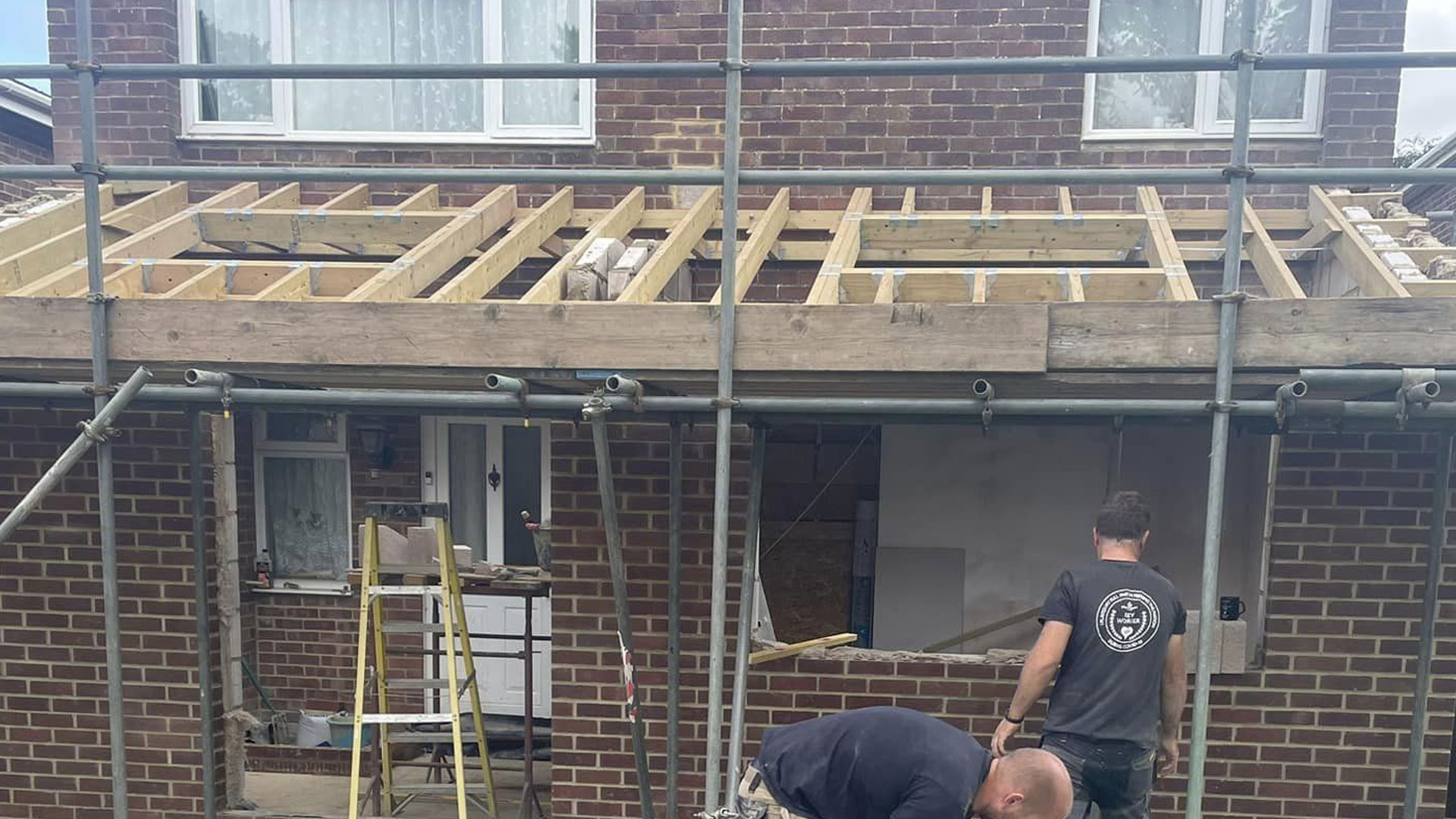 The Shape Create & Build team on site, new roof timbers going on over a rear extension with the scaffold up